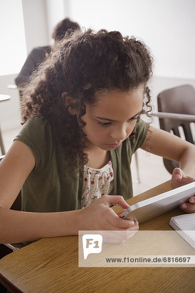 Portrait of schoolgirl (10-11) with digital tablet