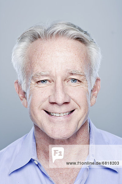 Portrait of smiling senior man  studio shot