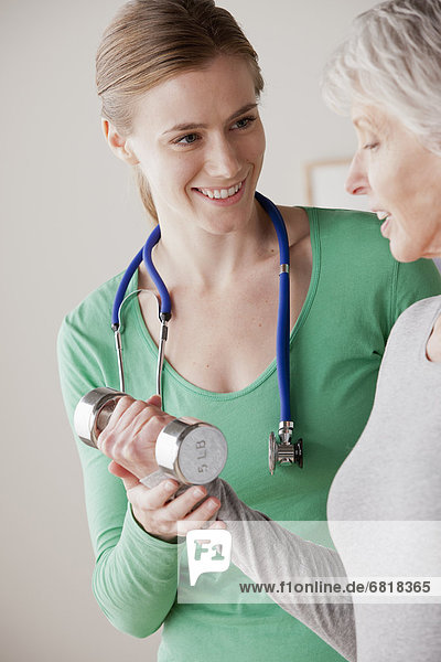 Female nurse with senior patient at home