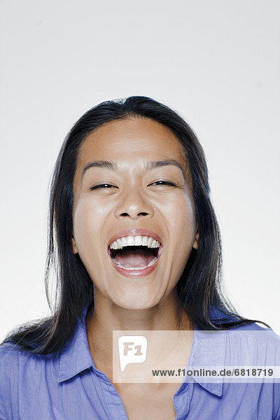 Portrait of laughing young woman  studio shot