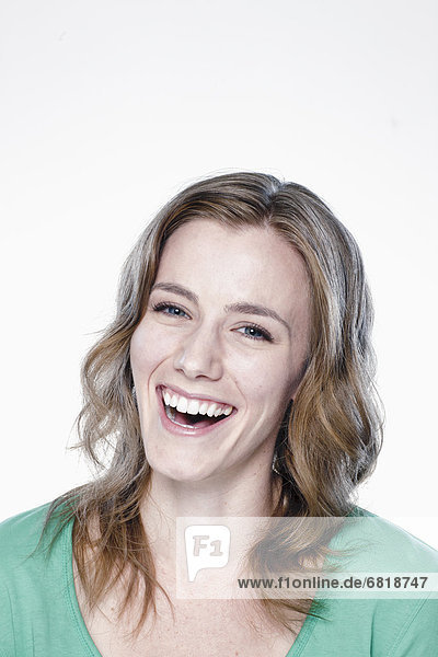 Portrait of laughing young woman  studio shot