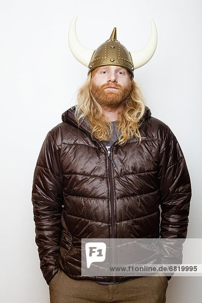 Studio Shot portrait of young man in Viking Helmet