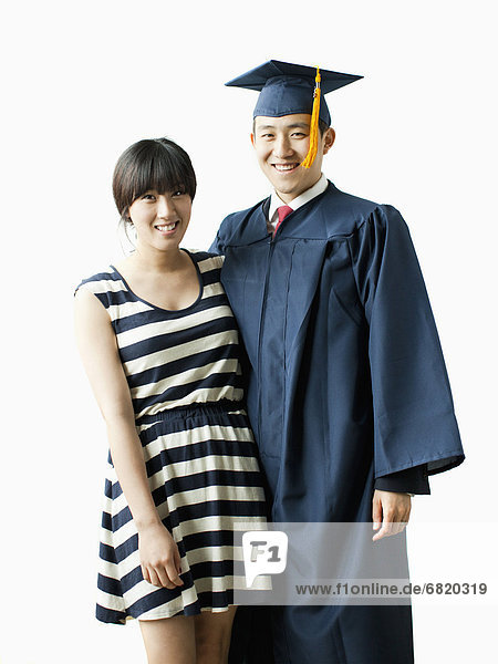 Portrait of young couple  man in graduation gown