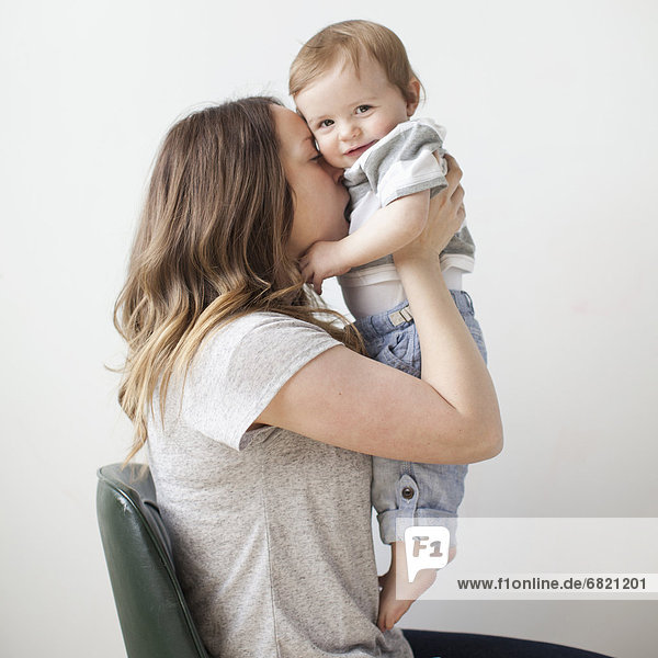 Portrait of young woman embracing baby boy (6-11 months)
