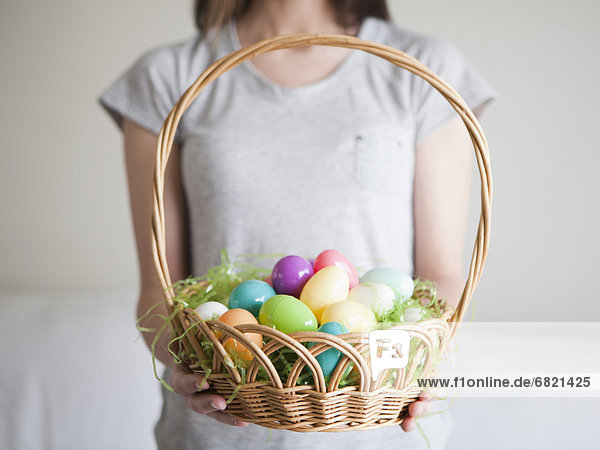 Young woman holding Easter egg basket