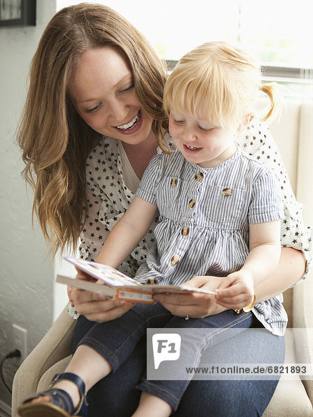 Young mother reading to toddler girl (2-3)