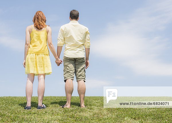 Couple standing on meadow