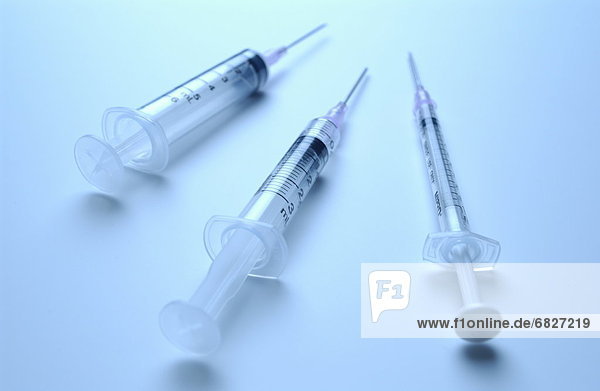 Three syringes with needles
