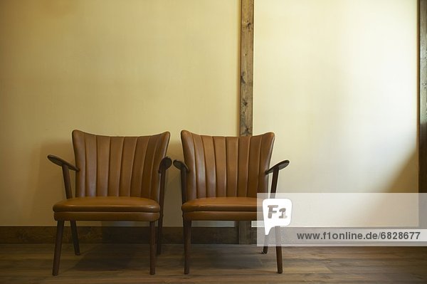 Two brown leather chairs.