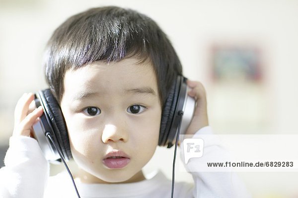 Little boy listening to headphones