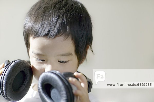 Little boy listening to headphones