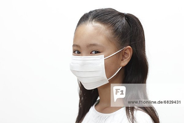 Young girl wearing a surgical mask