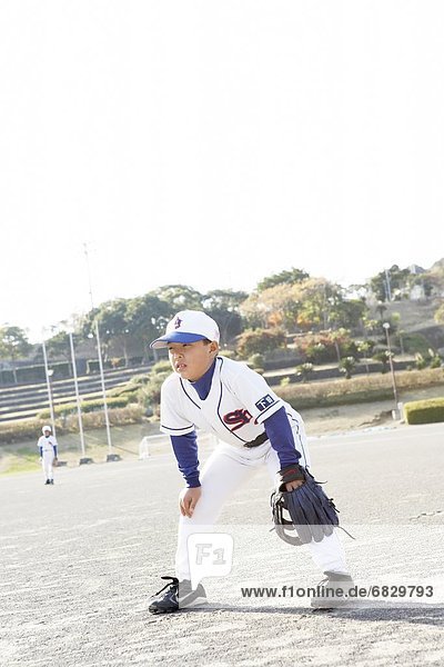 Boy in baseball team in field