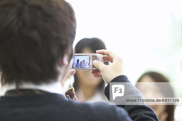 High school students taking picture with mobile phone  Japan