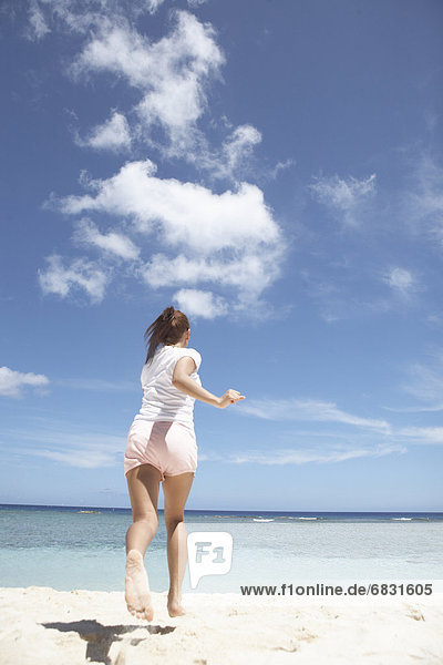 Young woman running on beach  Guam  USA