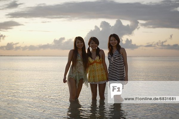 Young women standing in sea  Guam  USA