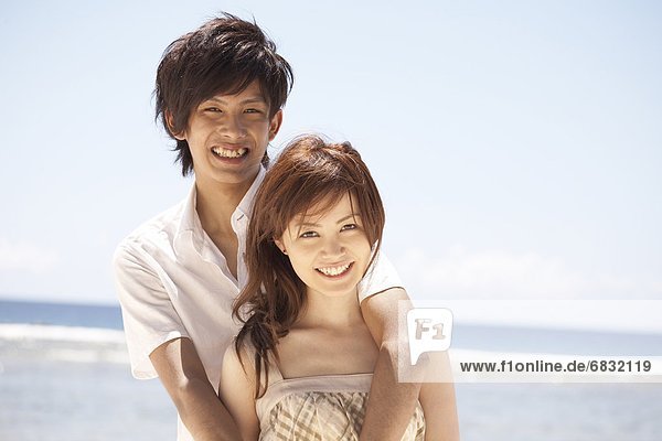 Portrait of young couple on beach  Guam  USA