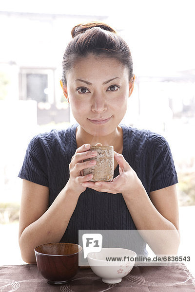 Young Woman Holding Tea Cup