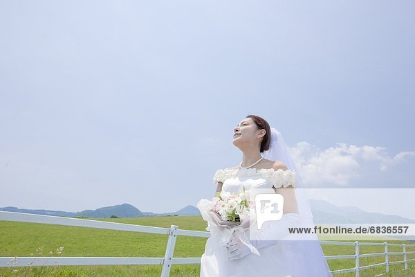 Bride standing in a meadow  Tochigi Prefecture  Honshu  Japan