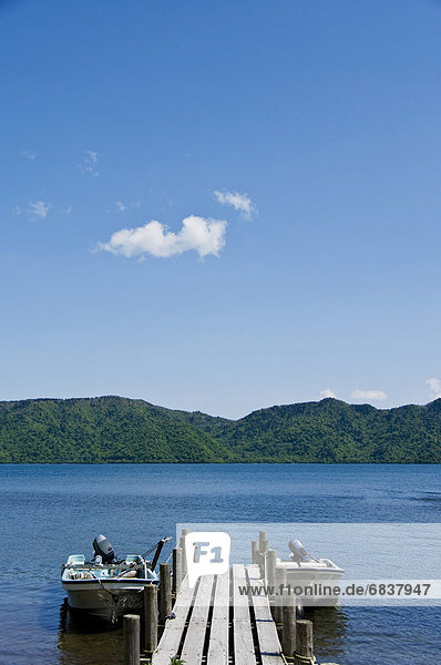 Pier by the lake  with mountain range in the background. Okunikko  Nikko  Tochigi Prefecture  Japan