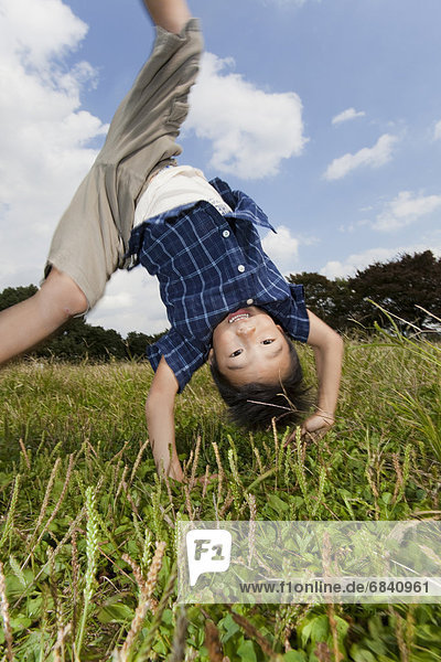 Boy doing a cartwheel  Japan