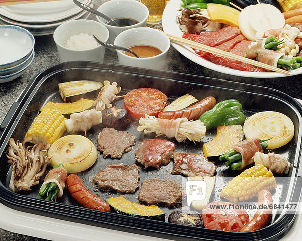 Vegetables and meat grilled on hot plate