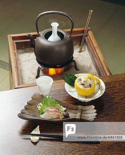 Sake and plate of sliced fish