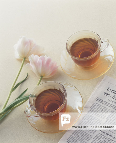 Two cups of tea with pink flowers