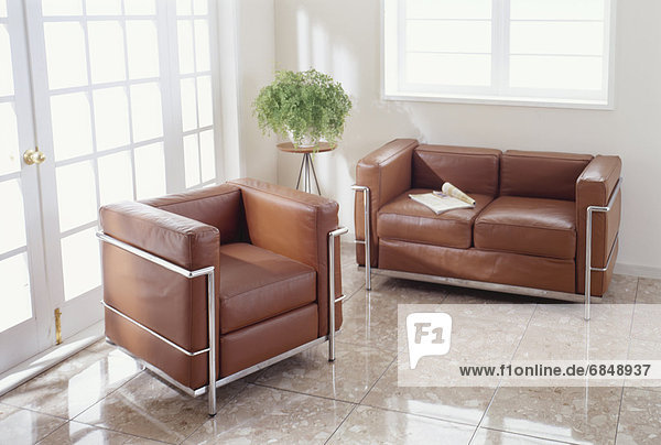 Brown leather sofa and armchair