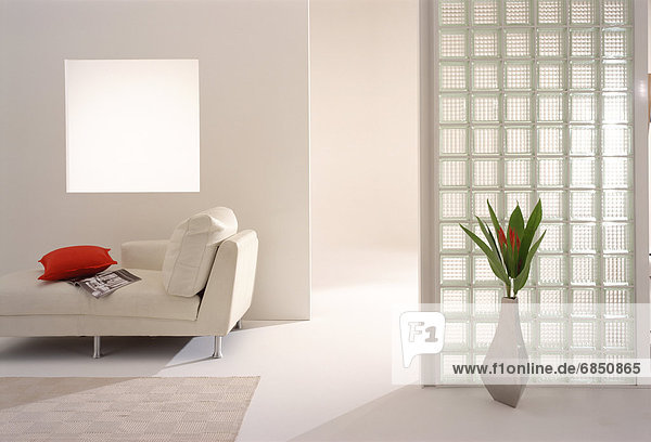 Vase of flowers and sofa in modern room
