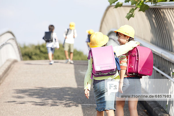 Elementary school students walking to school  rear view