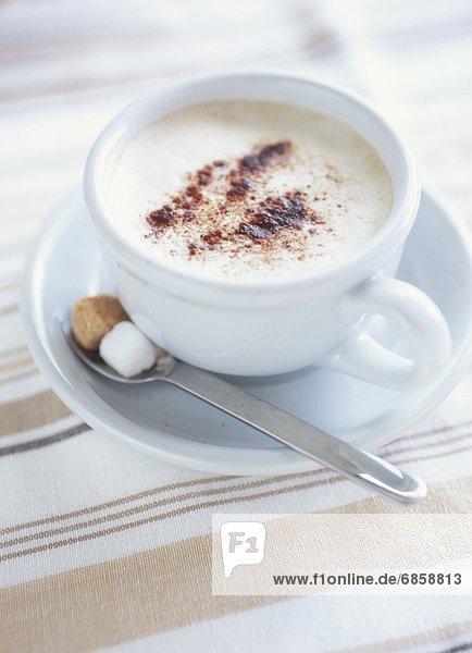 A Cup of Cappuccino With Sugar Cubes