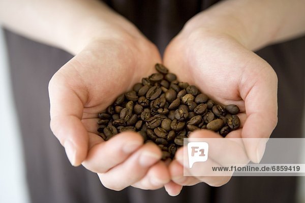 A Woman's Hands Holding Fresh Coffee Beans