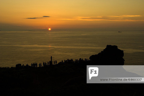 Silhouette of people watching sunset  Okinawa Prefecture  Japan