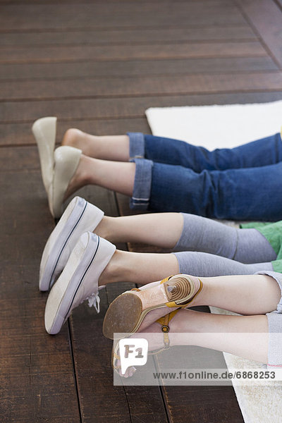 Three Women Lying on Rug  Focus on Legs