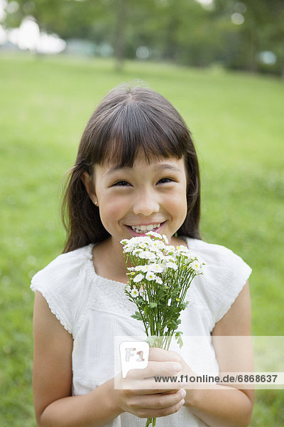 Girl Holding Bunch of Wildflowers