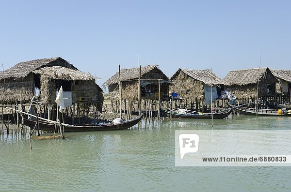 Bamboo huts and boats along a waterway  Irrawaddy delta  Myanmar (Burma)  Asia