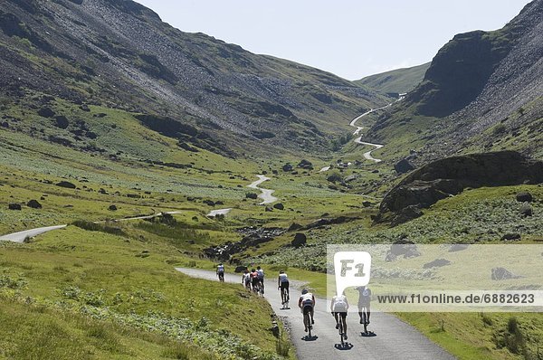 Cyclists ascending Honister Pass  Lake District National Park  Cumbria  England  United Kingdom  Europe