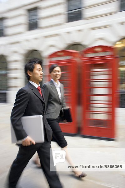 Businessman and Businesswoman Walking in London