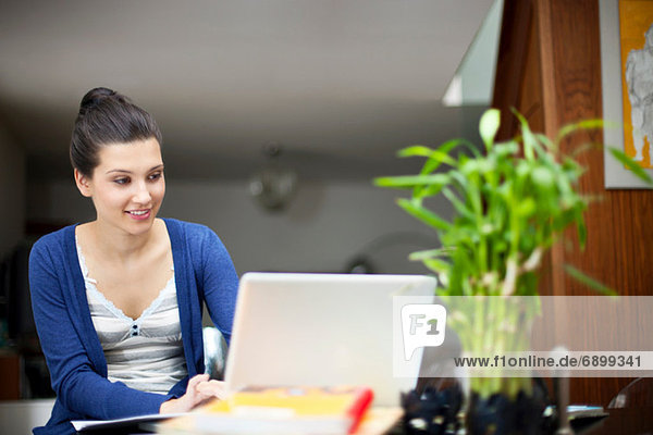 Young woman working from home on laptop