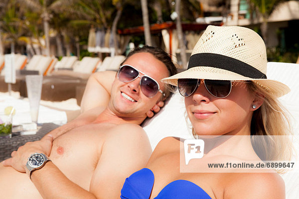 Couple sunbathing at Playa Del Carmen  Quintana Roo  Mexico