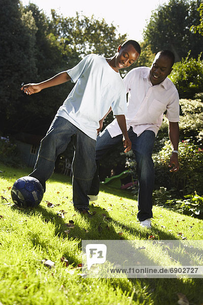 Father and Son Playing in Backyard