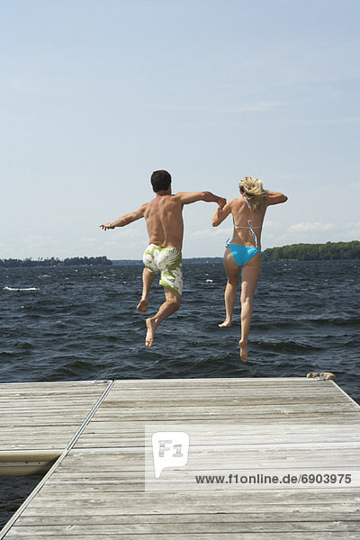 Couple Jumping Into Lake
