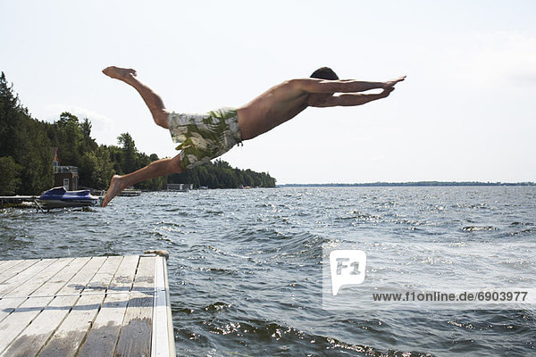 Man Jumping Into Lake