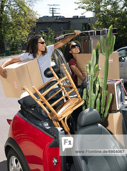 Couple Packing Car Full of Belongings