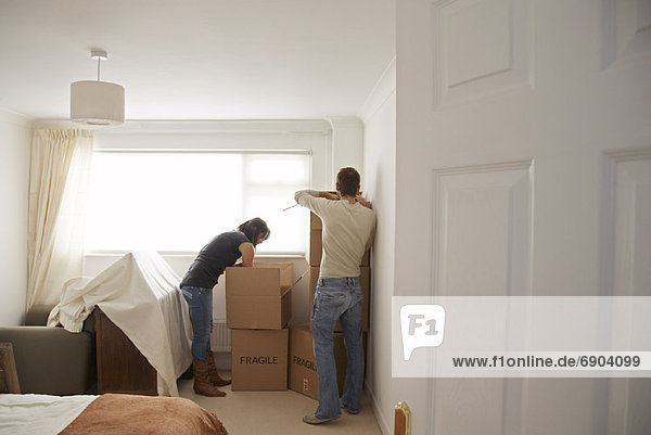 Couple with Boxes in New Home
