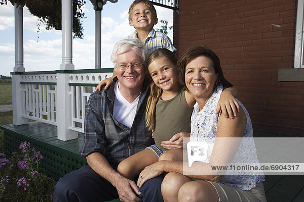 Couple with Grandchildren on Porch