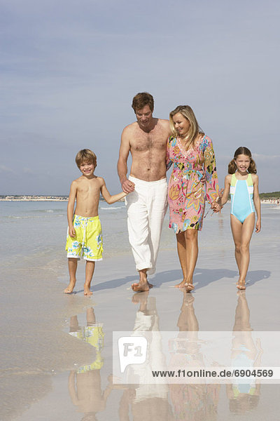 Family Walking along Beach  Majorca  Spain