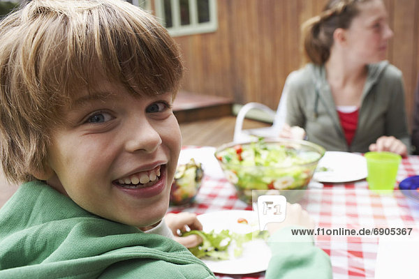 Boy and Girl at Outdoor Dinner Table