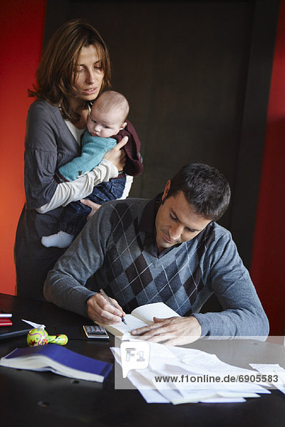Couple with Paperwork and Baby